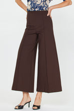 Load image into Gallery viewer, Brown wide-leg pants worn by a person on a white background