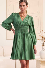 Load image into Gallery viewer, Woman wearing a green dress in an indoor setting