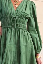 Load image into Gallery viewer, Green dress with long sleeves and a close-up of the waistband.