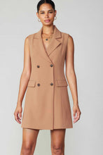 Load image into Gallery viewer, Looking elegant and stylish, the model wears a tan blazer dress with a double-breasted design and longline silhouette.