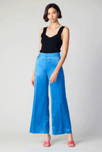 Load image into Gallery viewer, Indulge in the allure of these exquisite wide-leg pants. With a high waist and loose fit, they infuse your look with a burst of color and confidence. The clean waistband and precise creasing showcase the impeccable craftsmanship of these luxurious pants.

