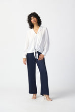 Load image into Gallery viewer, Satin top with notch collar, lapels, and centre-front ties. Puff sleeves with gold button cuffs. Sleek yokes at front and back for structure.
