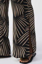 Load image into Gallery viewer, Sophisticated gauze pants with a tropical print, wide-leg design, side slits, and stylish side pockets for added functionality.
