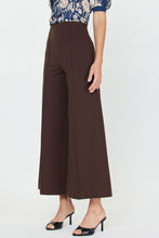 Load image into Gallery viewer, Brown wide-leg pants worn by a person on a white background
