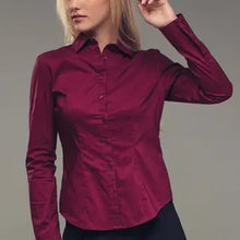 Load image into Gallery viewer, Woman wearing a burgundy shirt against a gray background
