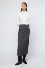 Load image into Gallery viewer, Exquisite wool blend skirt complemented by a refined white cotton poplin shirt with delicate beading and double button cuffs.
