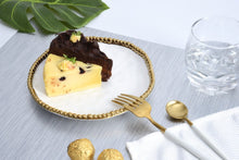 Load image into Gallery viewer, Round appetizer/dessert plate in Golden Salerno. Gleaming white porcelain with lustrous gold beads in titanium. Food, dishwasher, and oven safe.
