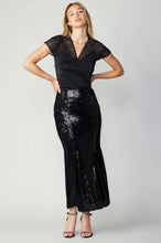 Load image into Gallery viewer, A stylish black sequin skirt that adds a touch of sparkle to any outfit.
