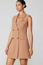 Load image into Gallery viewer, A model wearing a tan dress with a buttoned front. Sleeveless double-breasted longline vest dress exuding elegance and style.
