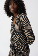 Load image into Gallery viewer, Exquisite gauze top featuring a tropical print, front knot, V-neckline, and three-quarter sleeves for modern glamour.

