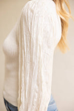 Load image into Gallery viewer, Close-up of a person wearing a white textured sweater with a blurred background
