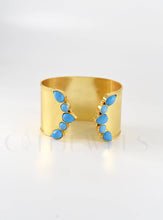 Load image into Gallery viewer, Gold cuff bracelet with turquoise stones on a white background
