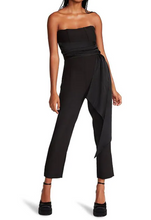 Load image into Gallery viewer, Elegant woman in a black jumpsuit with a bow - Harlan Strapless Wrap Belt Jumpsuit.
