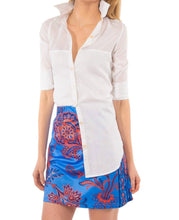 Load image into Gallery viewer, Stylish woman in white shirt and floral pants, highlighting our range of durable white cotton voile tops.
