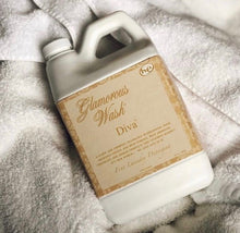 Load image into Gallery viewer, A bottle of Diva laundry wash placed on a towel, exuding an air of glamour and elegance.
